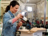 photo of woman packing a gift box