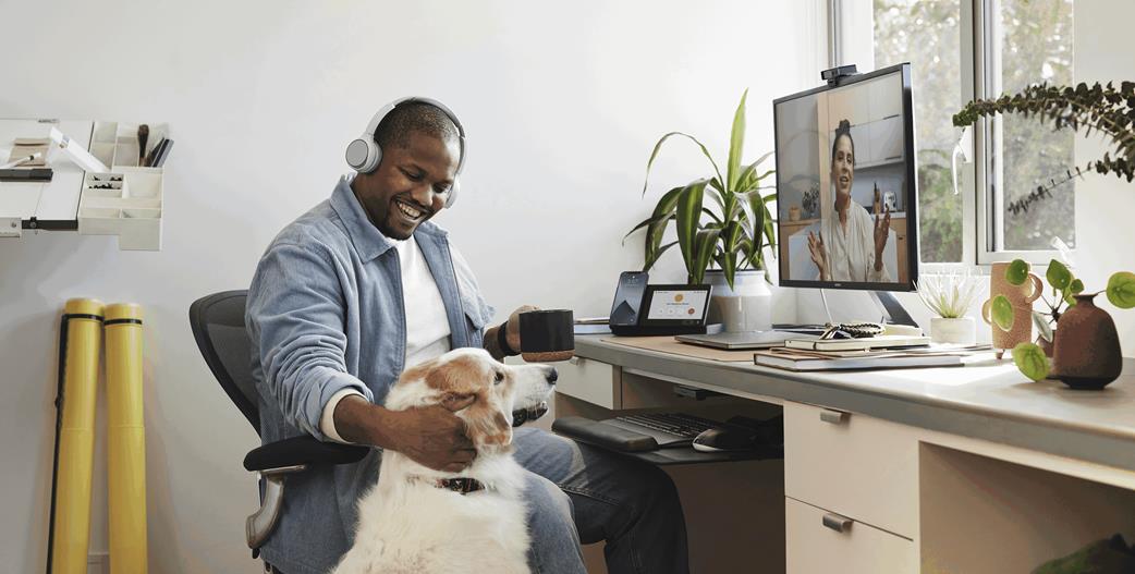 Employee working from home using a Cisco Headset 730 and Webex Desk Camera
