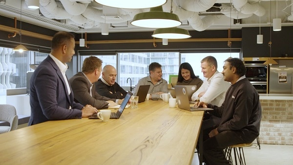 A business team collaborates around a desk