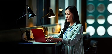 Businesswoman using laptop in modern office