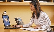 Picture of woman talking to someone via a laptop