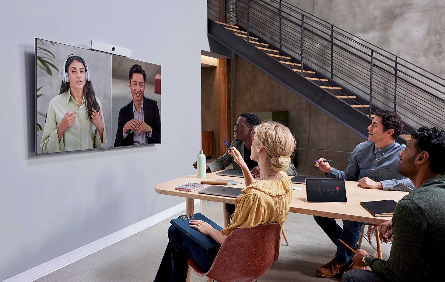 Webex Room Bar paired with dual flat screen displays for video meeting and content sharing in a mid-sized meeting room