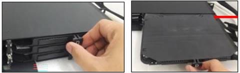 A hand holding a black deviceDescription automatically generated