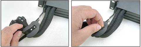 A close-up of a hand holding a black objectDescription automatically generated