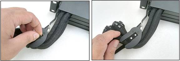 A hand holding a black objectDescription automatically generated