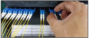 A hand holding blue and white cablesDescription automatically generated