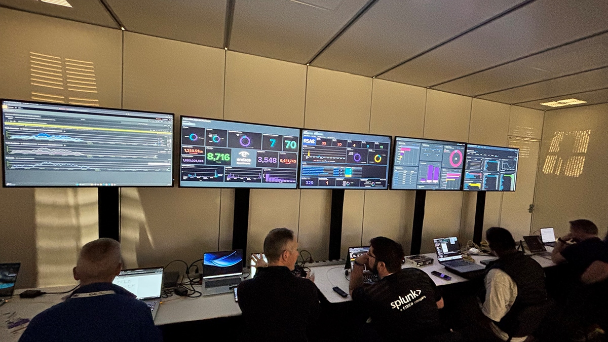 A group of people sitting at desks with computersAI-generated content may be incorrect.
