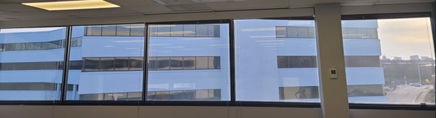 A window with a view of a buildingAI-generated content may be incorrect.