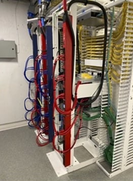 A group of wires on a rackDescription automatically generated with medium confidence