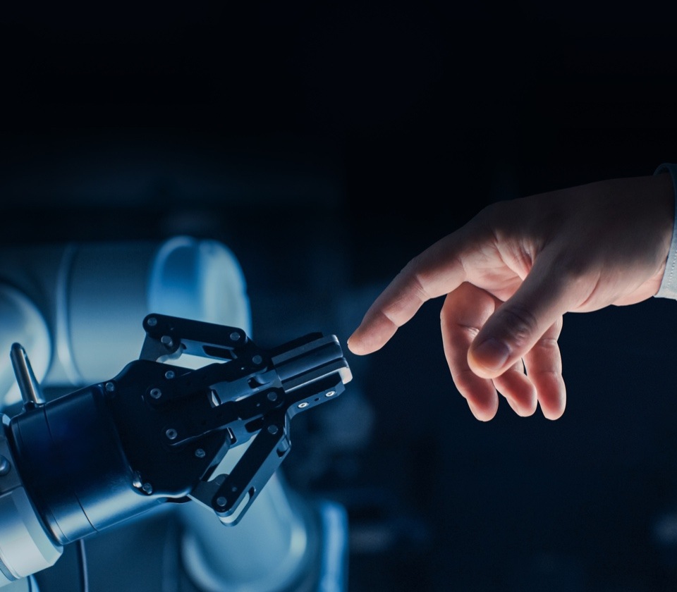 Human and robotic hand touching at fingers