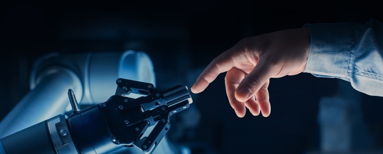 Human and robotic hand touching at fingers