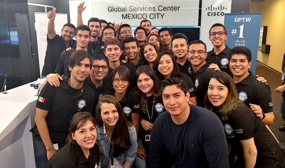Large group of people huddled together and smiling in Cisco's Mexico City office.