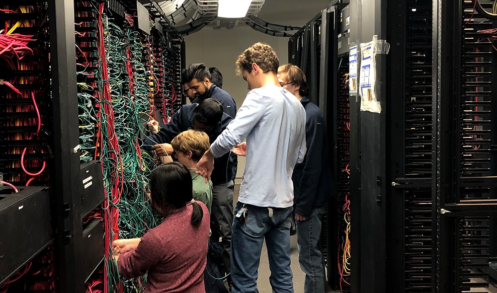 Multiple people working together on Cisco hardware.