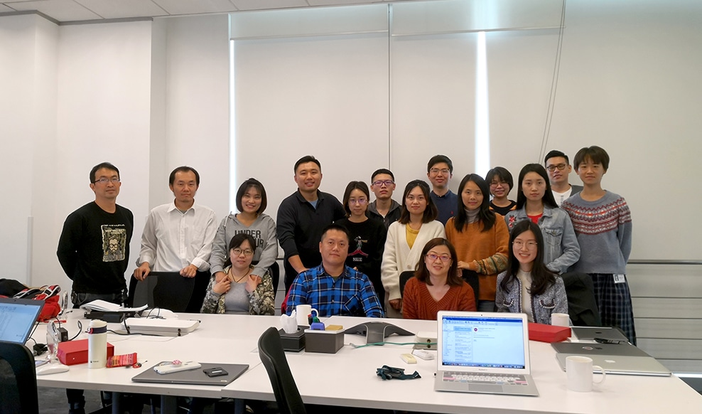 Seventeen people smiling for a group photo at our office in China