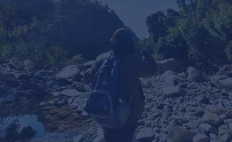 Female with Cisco backpack hiking in mountains in India