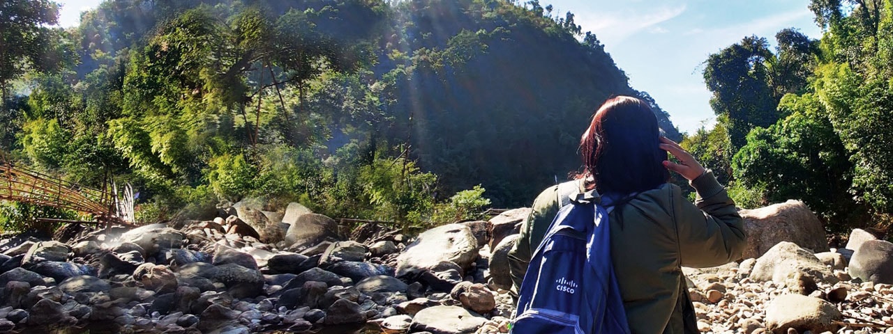 Female with Cisco backpack hiking in mountains in India