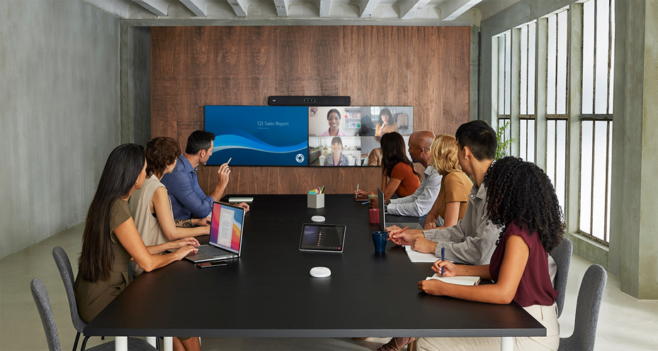 Cisco Room Bar Pro paired with dual flat screen displays for video meeting and content sharing running the native Microsoft Teams Rooms experience