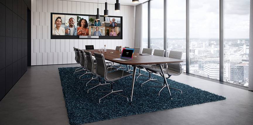 The Cisco Room Kit EQ in a conference room with the Quad Camera, the table-stand Room Navigator, and the Cisco Table Microphone Pro