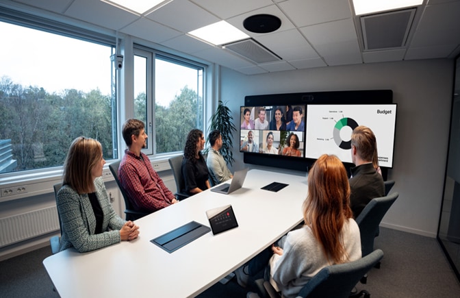 A Room Kit EQX with 65” dual screens in combined deployment with a Ceiling Microphone Pro for directional speech capture.