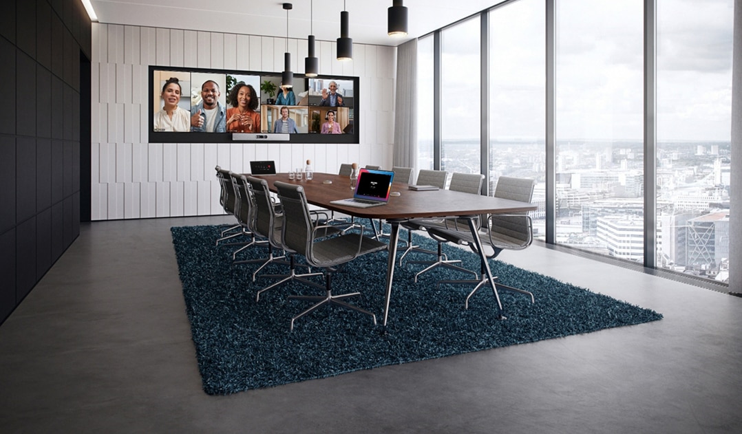 The Cisco Room Kit EQ in a conference room with the Quad Camera, the table-stand Room Navigator, and the Cisco Table Microphone Pro.