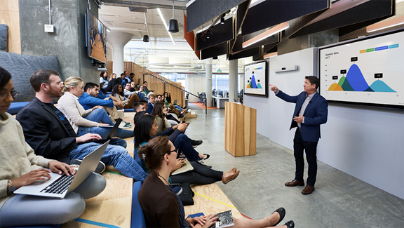 The Room Kit Pro with the Quad Camera, external dual-screens and the Precision 60 pan-tilt-zoom camera deployed in an auditorium