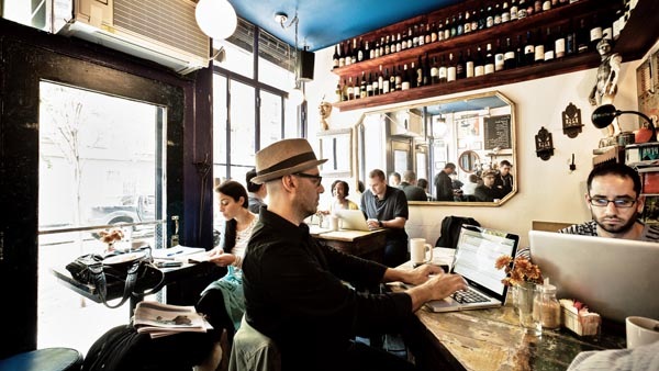 Man uses his laptop at a bar