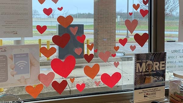Credit union window with paper heart decorations
