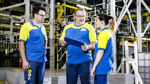 Unilin factory workers collaborating in a warehouse
