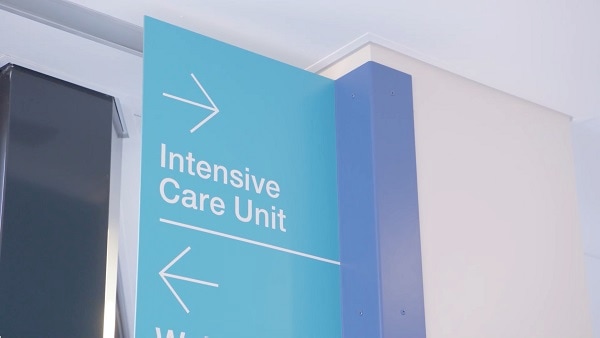 A sign giving directions to the ICU, where virtual visitation allows patients and families to remain connected.