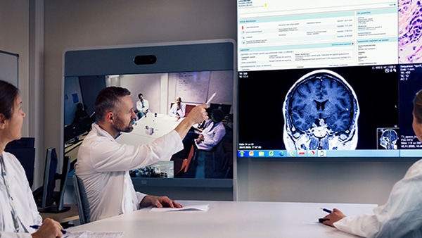Doctors in video conference discuss images of human brain
