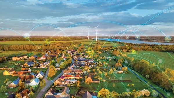 An illustration of a landscape with wind turbines behind a neighborhood