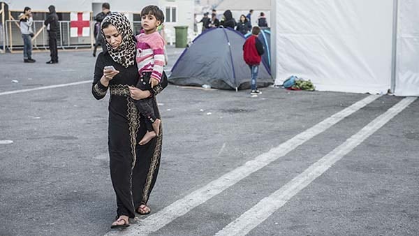Displaced mother in Slovenia holding child