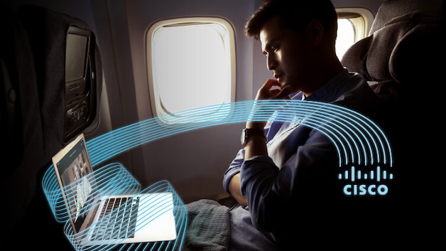 Man on airplane working on laptop