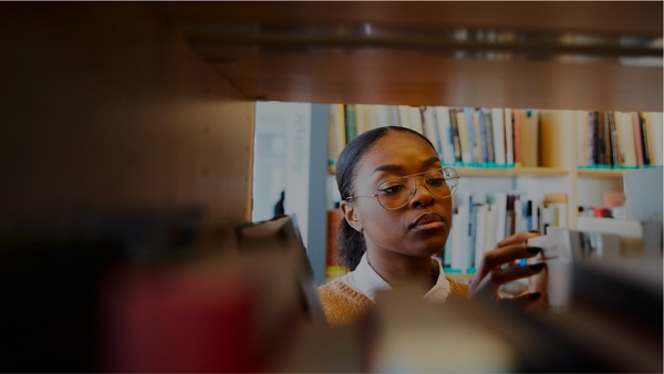 Woman looking at books in a library