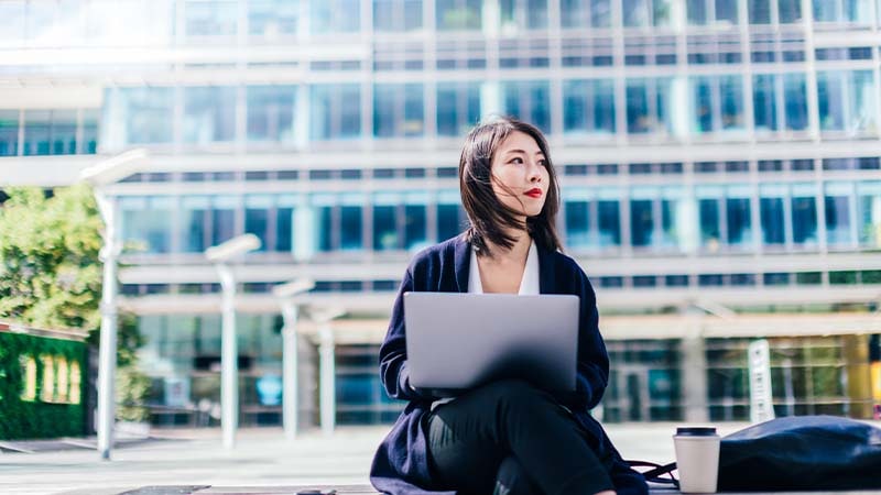 A person using a laptop outside