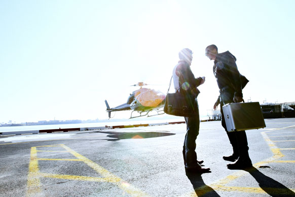 Two people on helicopter tarmac