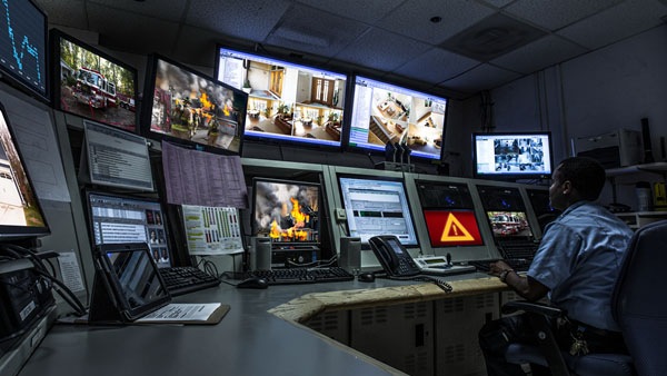 Person seated in front of multiple computer monitors