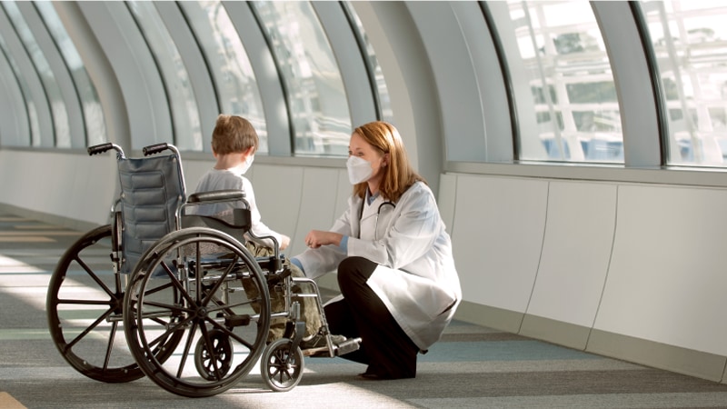 Child in wheelchair with doctor