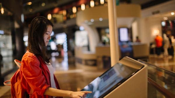retail shopper interacting with digital signage