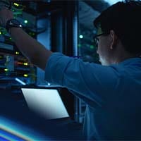 Man working at a data center rack 