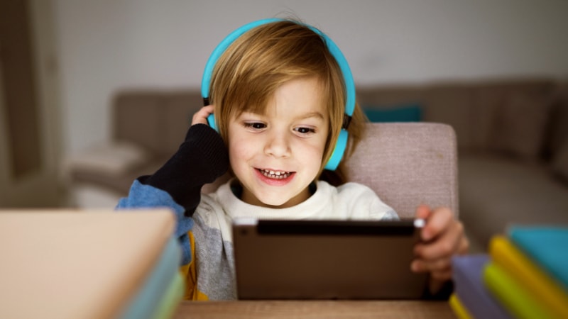 Child on tablet with headphones
