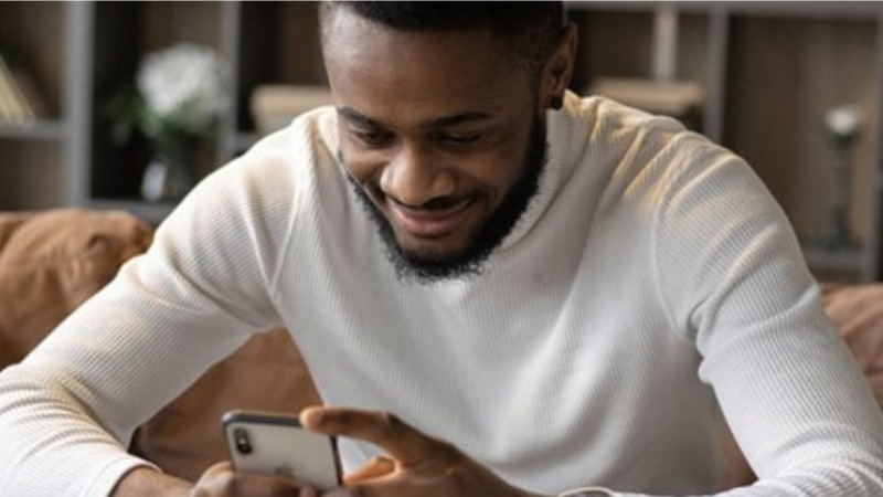 Person smiling while on smartphone