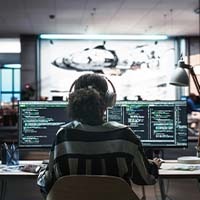 Women at multiple computer screens 
