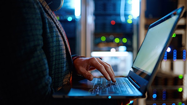 Man works on a network via a laptop