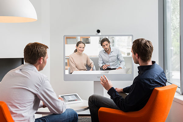 Four people in a teleconference meeting