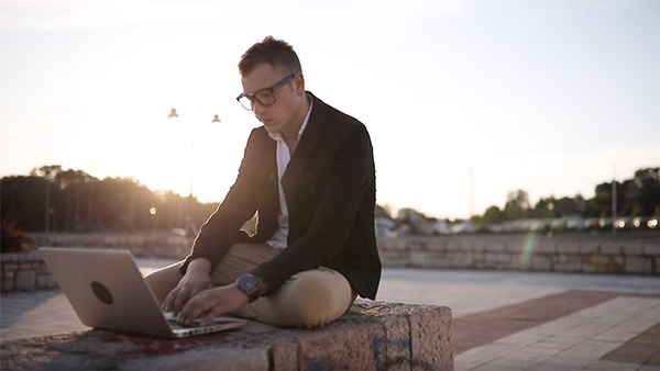 Man working on laptop outside