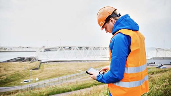 Person viewing tablet in industrial setting