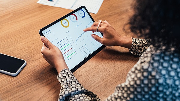 Woman reviewing charts on tablet