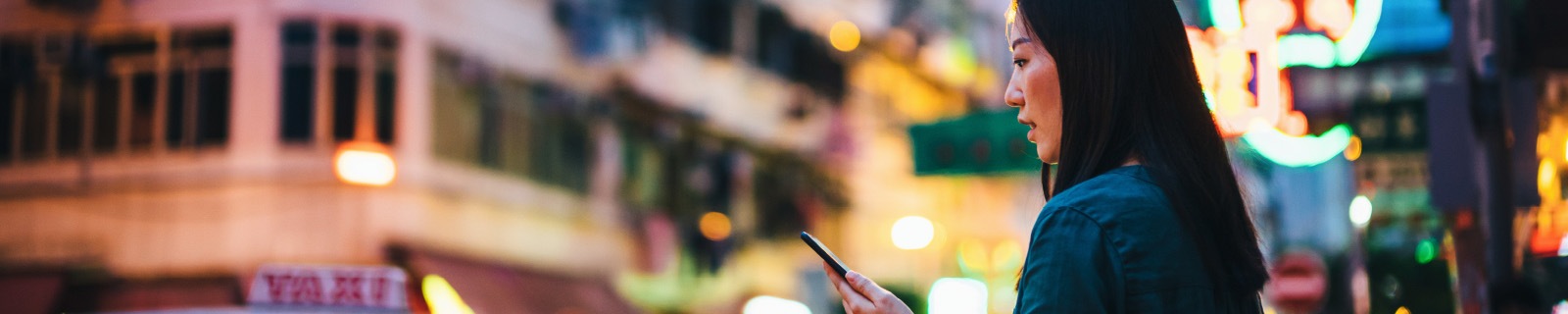 Woman reading 2023 global networking trends introduction on cell phone