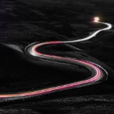 A car racing fast on a windy road